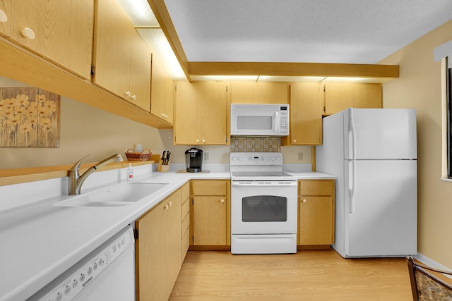 kitchen featuring sink, white appliances, tasteful backsplash, a textured ceiling, and light hardwood / wood-style flooring