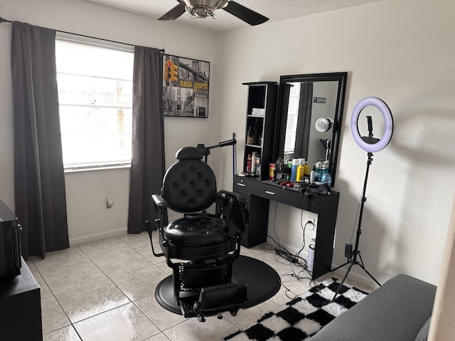 miscellaneous room featuring ceiling fan, a textured ceiling, and light tile patterned floors