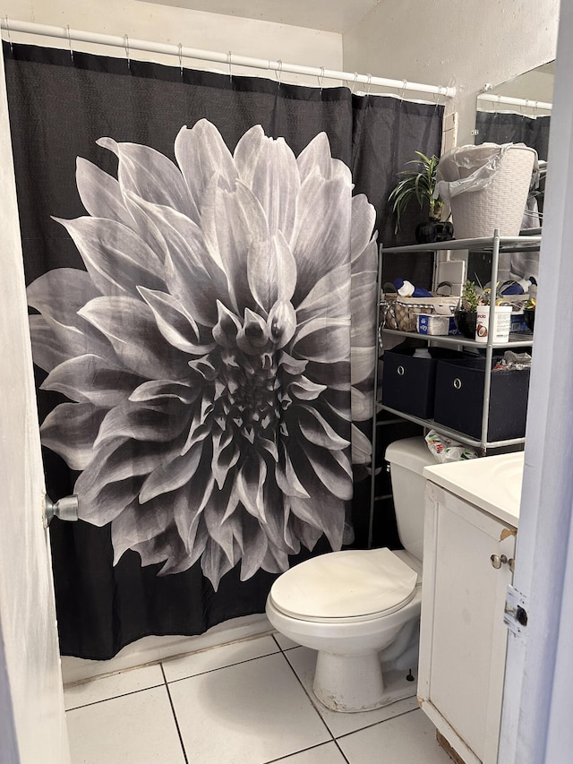 bathroom featuring vanity, toilet, a shower with curtain, and tile patterned flooring