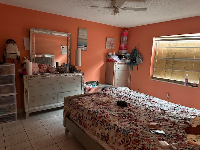 bedroom featuring light tile patterned flooring, a textured ceiling, and ceiling fan