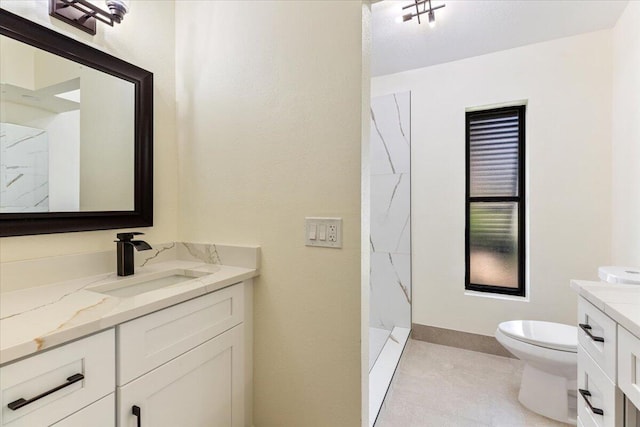 bathroom with vanity, toilet, and walk in shower