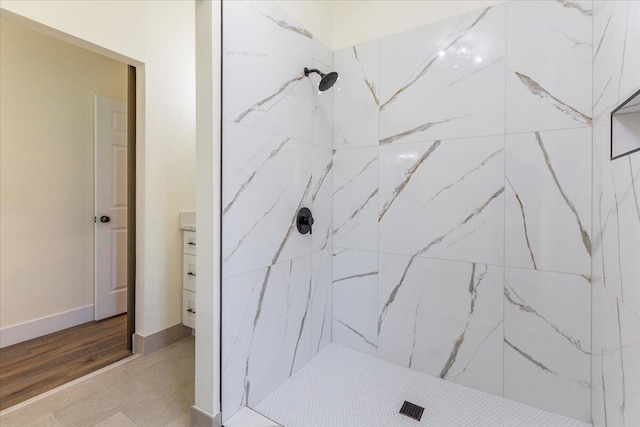 bathroom featuring vanity and tiled shower