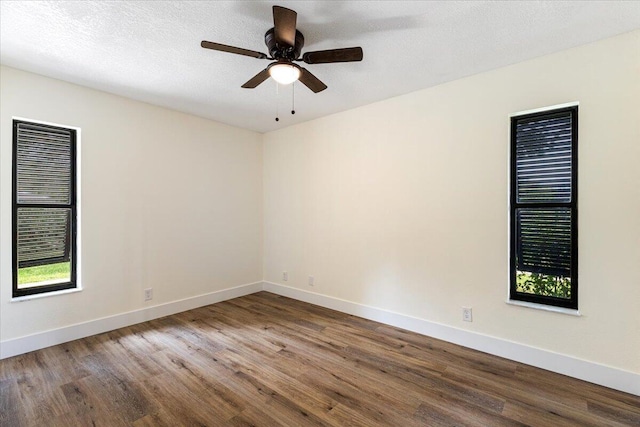 empty room with hardwood / wood-style floors and ceiling fan