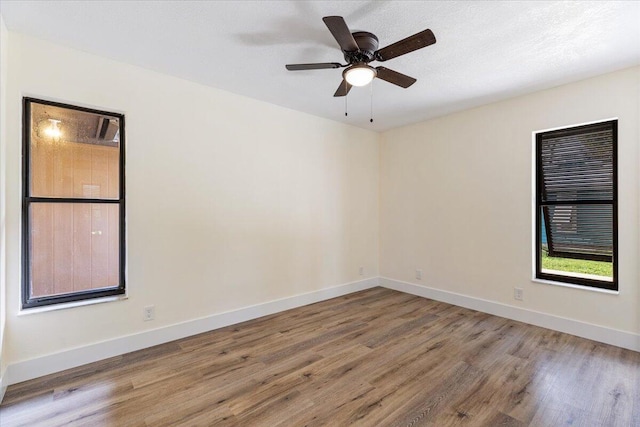 unfurnished room featuring hardwood / wood-style floors and ceiling fan