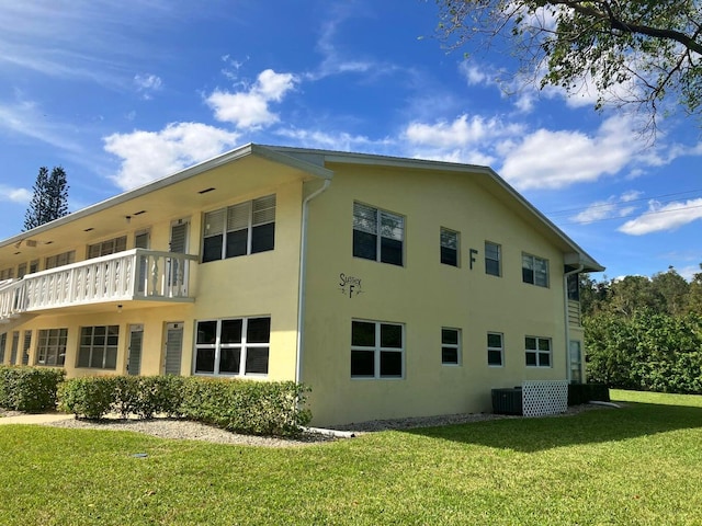 view of home's exterior featuring central AC unit and a yard