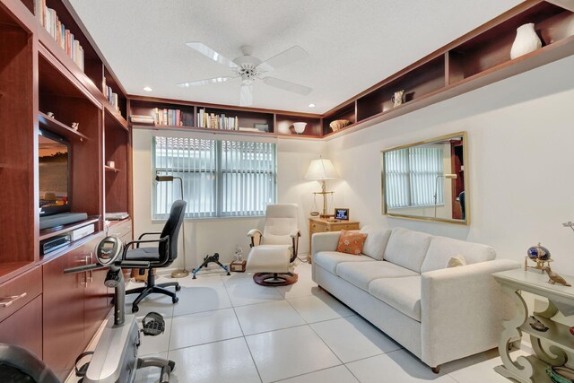 tiled home office featuring a textured ceiling and ceiling fan