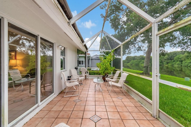 unfurnished sunroom featuring a water view and plenty of natural light