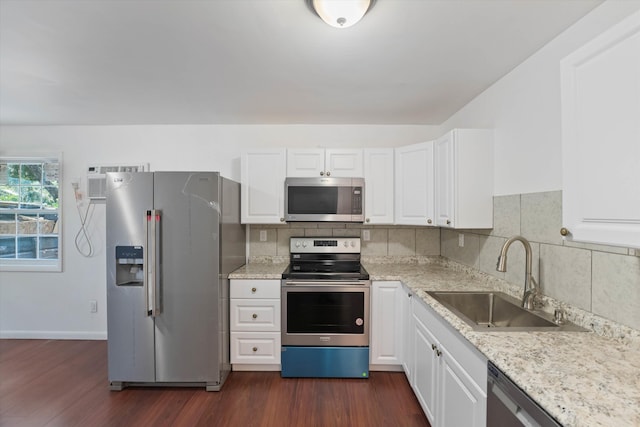 kitchen with sink, dark wood-type flooring, stainless steel appliances, and white cabinets