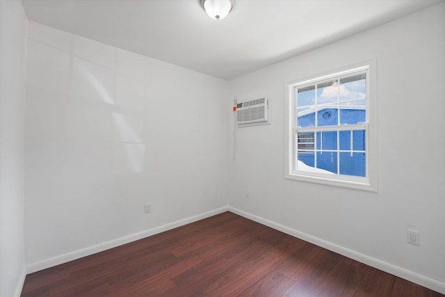 unfurnished room with hardwood / wood-style floors and a wall mounted air conditioner