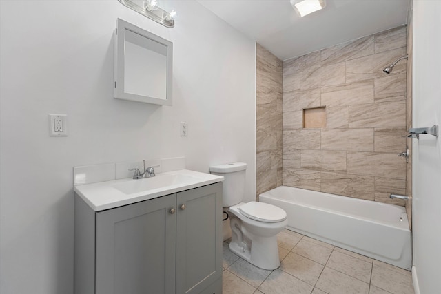 full bathroom with tile patterned floors, tiled shower / bath combo, vanity, and toilet