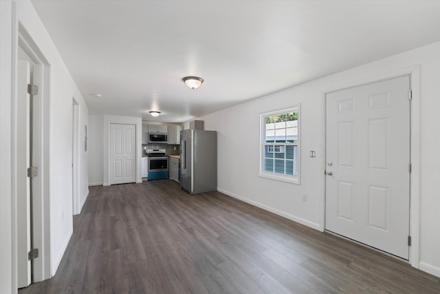 unfurnished living room featuring dark hardwood / wood-style flooring