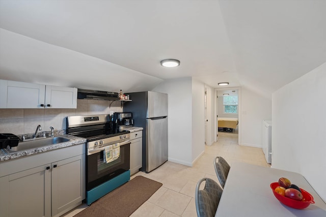 kitchen with appliances with stainless steel finishes, vaulted ceiling, sink, and ventilation hood