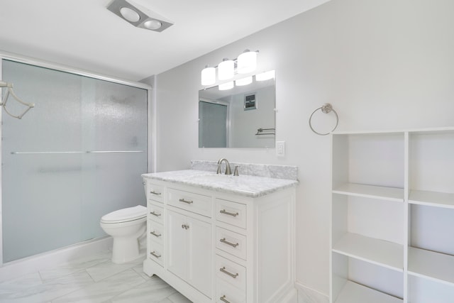 bathroom with vanity, toilet, and a shower with door