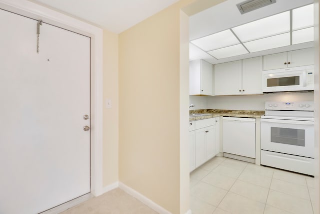 kitchen featuring sink, light tile patterned floors, white appliances, and white cabinetry