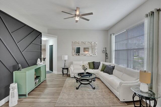 living room featuring ceiling fan and light hardwood / wood-style flooring