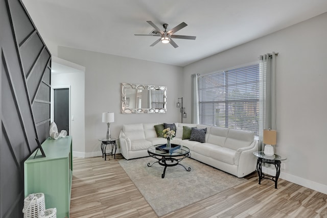 living room with light hardwood / wood-style floors and ceiling fan