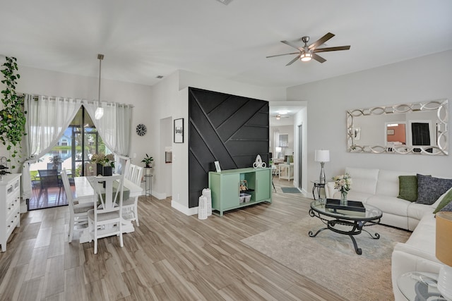 living room with ceiling fan and light wood-type flooring