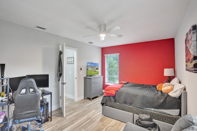 bedroom with light hardwood / wood-style floors and ceiling fan