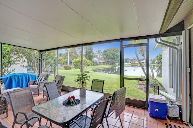 sunroom / solarium featuring a water view and plenty of natural light