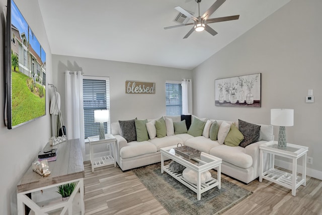 living room featuring hardwood / wood-style flooring, vaulted ceiling, and ceiling fan