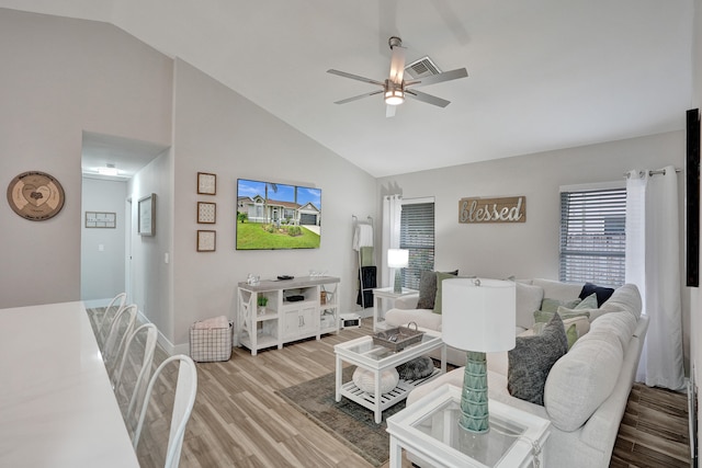 living room featuring hardwood / wood-style flooring, ceiling fan, and high vaulted ceiling