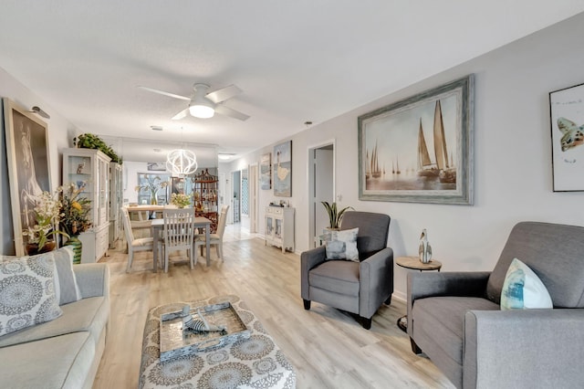 living room featuring light wood-type flooring and ceiling fan