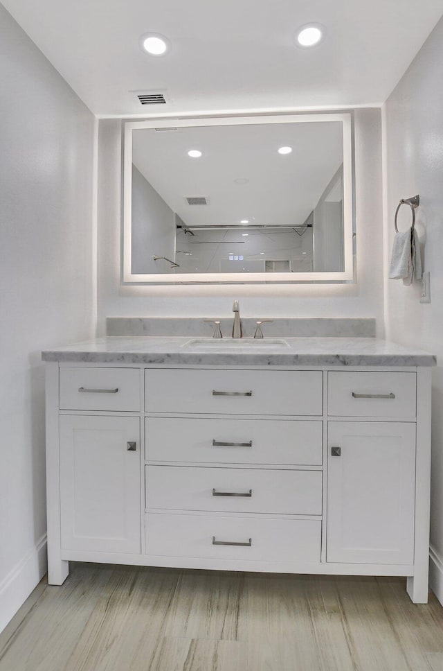 bathroom with vanity and walk in shower