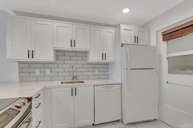 kitchen featuring white cabinetry, sink, backsplash, and white appliances