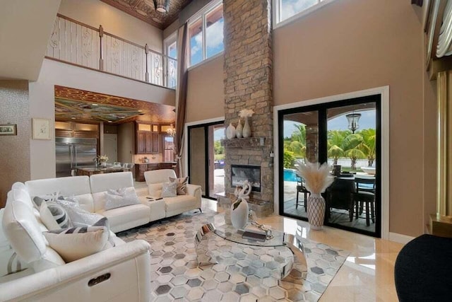 living room featuring a fireplace and a high ceiling