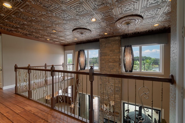 hall featuring crown molding and hardwood / wood-style floors