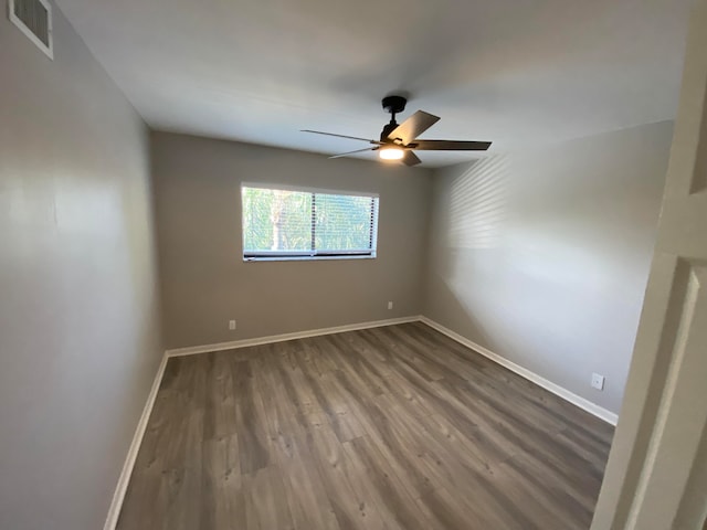 spare room featuring wood-type flooring and ceiling fan