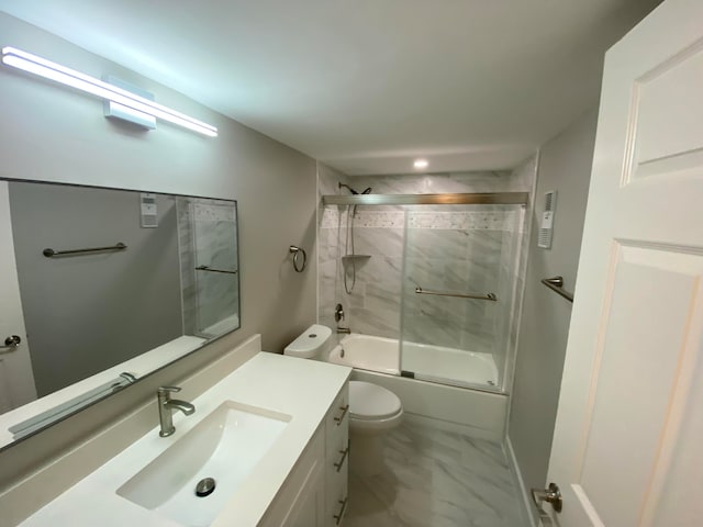 full bathroom featuring shower / bath combination with glass door, vanity, and toilet