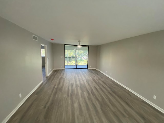 unfurnished room with dark hardwood / wood-style floors