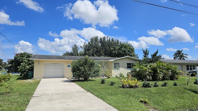 view of front of property featuring a front yard and a garage