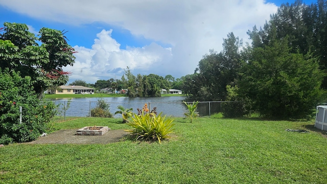 view of yard with a water view and a fire pit