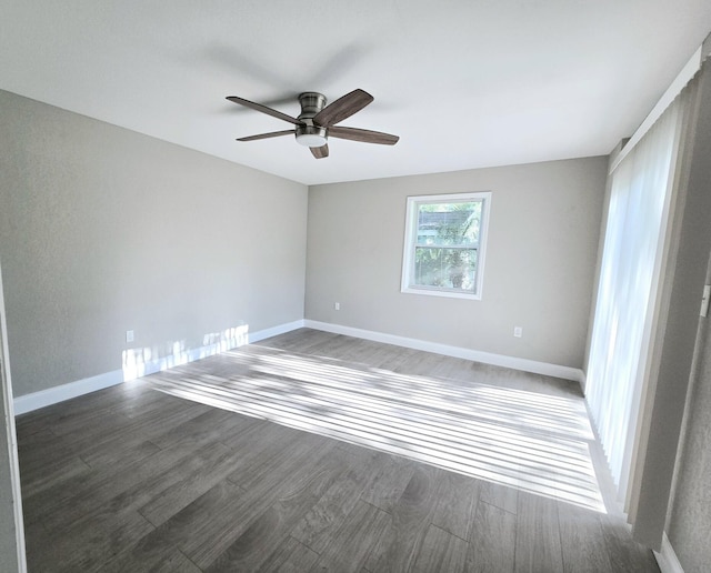 empty room featuring dark hardwood / wood-style floors and ceiling fan