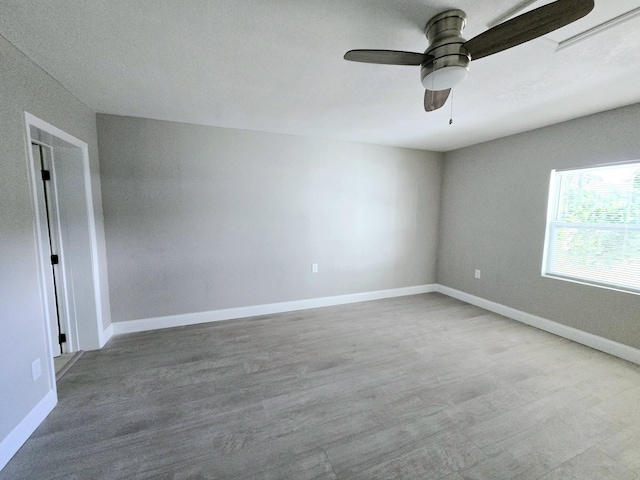 empty room featuring hardwood / wood-style floors and ceiling fan