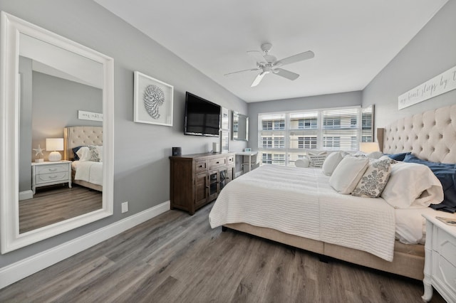 bedroom with a ceiling fan, baseboards, and wood finished floors