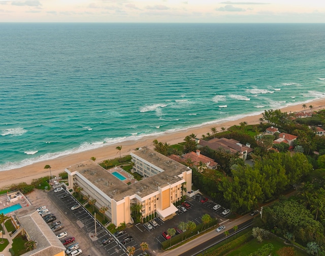 drone / aerial view with a water view and a view of the beach