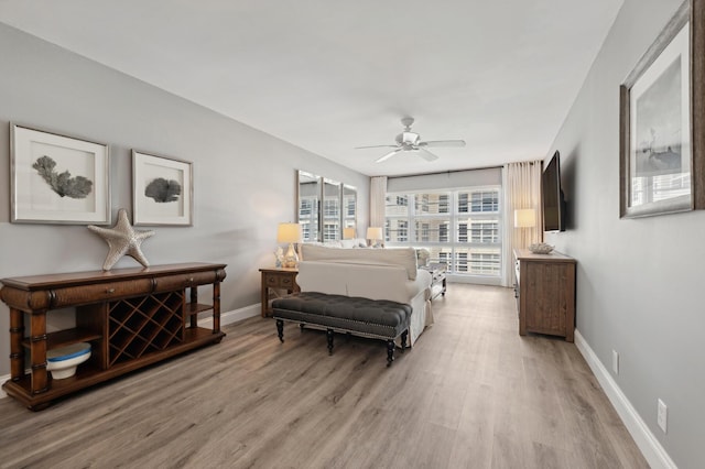 bedroom with light wood-style floors and baseboards