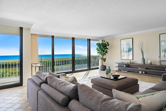 living room featuring a wealth of natural light, a water view, and expansive windows