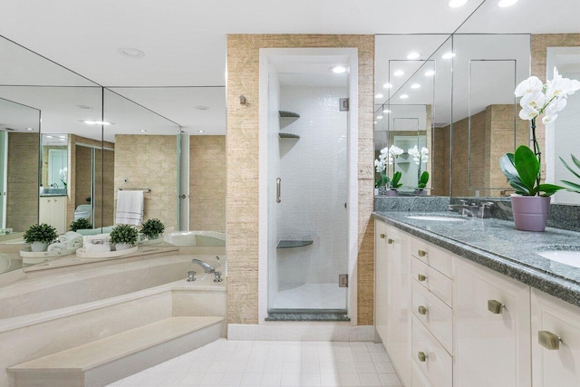 bathroom with vanity and shower with separate bathtub