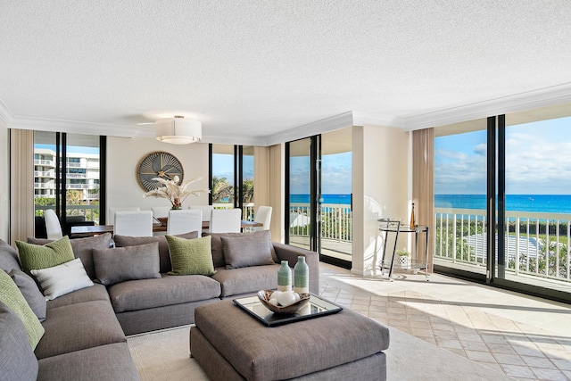 living room with a textured ceiling, a water view, expansive windows, and light tile patterned flooring