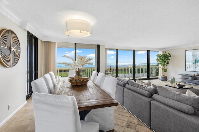 dining room with a textured ceiling, floor to ceiling windows, and ornamental molding