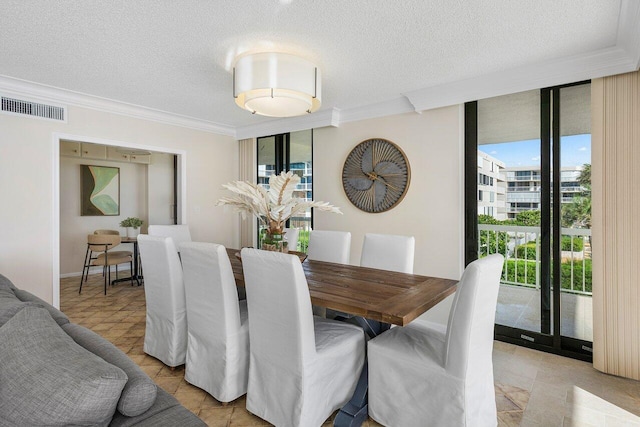 tiled dining room with a wall of windows, a wealth of natural light, and ornamental molding