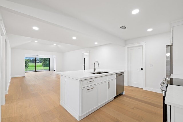 kitchen with stove, sink, light hardwood / wood-style flooring, a center island with sink, and white cabinetry