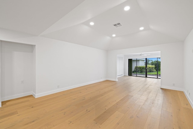 unfurnished living room featuring vaulted ceiling and light hardwood / wood-style flooring