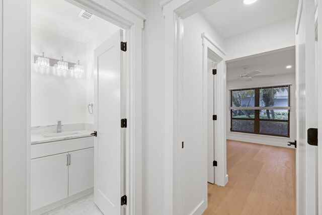 unfurnished living room featuring ceiling fan and light hardwood / wood-style floors