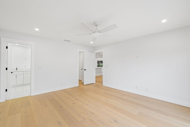 spare room with light hardwood / wood-style floors and ceiling fan