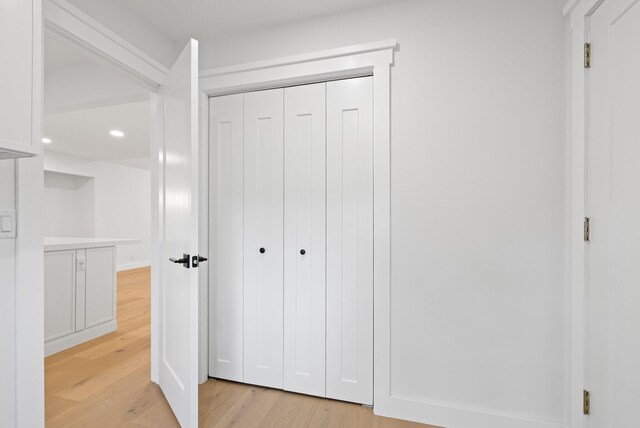 bathroom featuring wood-type flooring and an enclosed shower